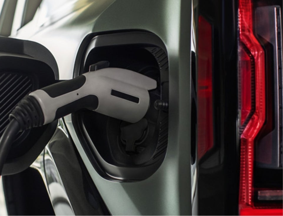 Close up of charging port with charger plugged in on a GMC Hummer EV SUV - Silveira Healdsburg in Healdsburg CA